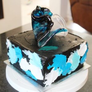 Black, blue and white cake with isomalt sail